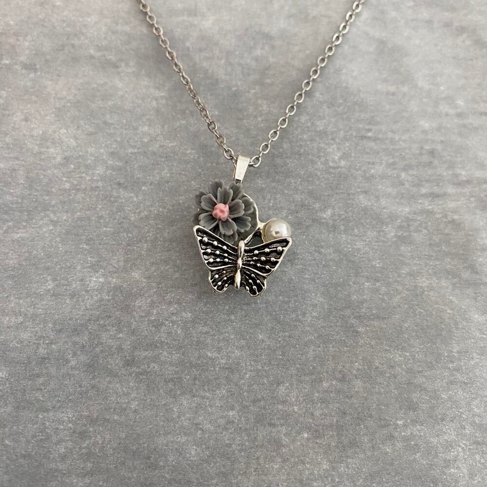 Silver butterfly necklace with flower and faux pearl detail